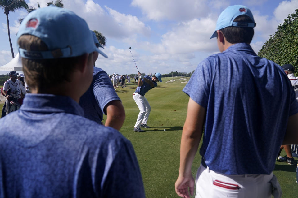 Members of the USA team watch as Stewart Hagestad tees off during a practice day for the Walker Cup golf tournament at Seminole Golf Club in Juno Beach, Fla., Friday, May 7, 2021. (AP Photo/Gerald Herbert)