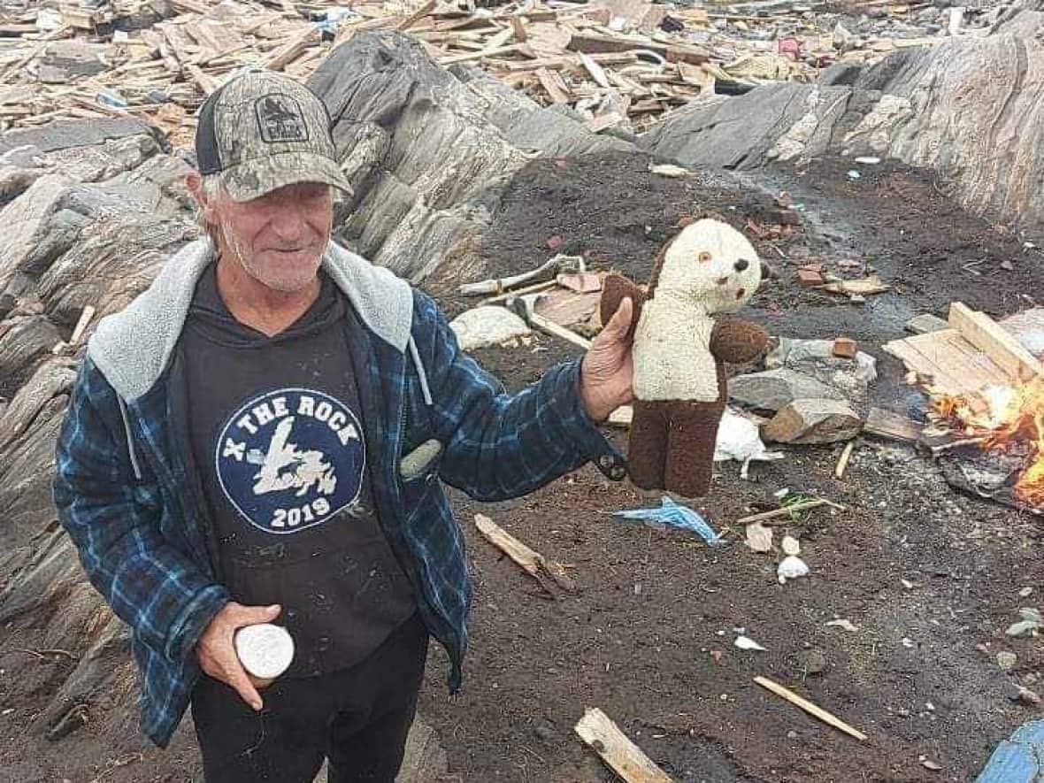 David Robin Ingrim lost his two homes and a shed, and while walking on a beach near his property, spotted his 60-year-old teddy bear that he will now give to his three-month-old grandson. (Submitted by Scott Strickland - image credit)