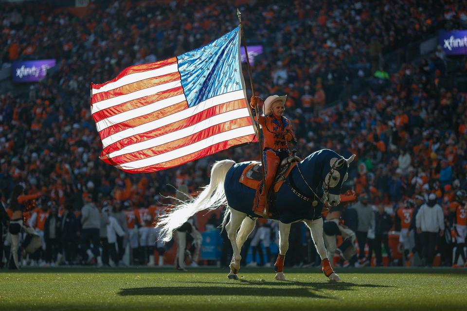 November 26, 2023. Denver, Colorado, USA. After scoring a touchdown in the first quarter of a game against the Cleveland Browns at Empower Field at Mile High, Denver Broncos mascot Thunder, ridden by Ann Judge, crosses the field holding an American flag. Required Credit: Isaiah J. Downing-USA TODAY Sports