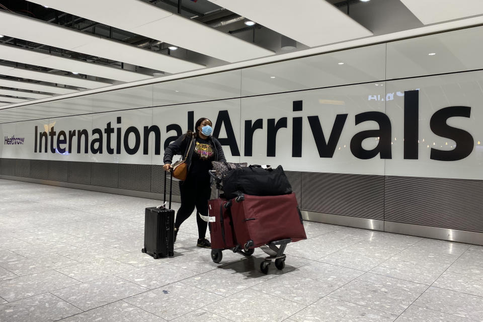 A passenger pushes a trolley through the Arrival Hall of Terminal 5 at London's Heathrow Airport after arriving into the UK following the suspension of the travel corridors. Passengers arriving from anywhere outside the UK, Ireland, the Channel Islands or the Isle of Man must have proof of a negative coronavirus test and self-isolate for 10 days. Picture date: Monday January 18, 2021. (Photo by Kirsty O'Connor/PA Images via Getty Images)