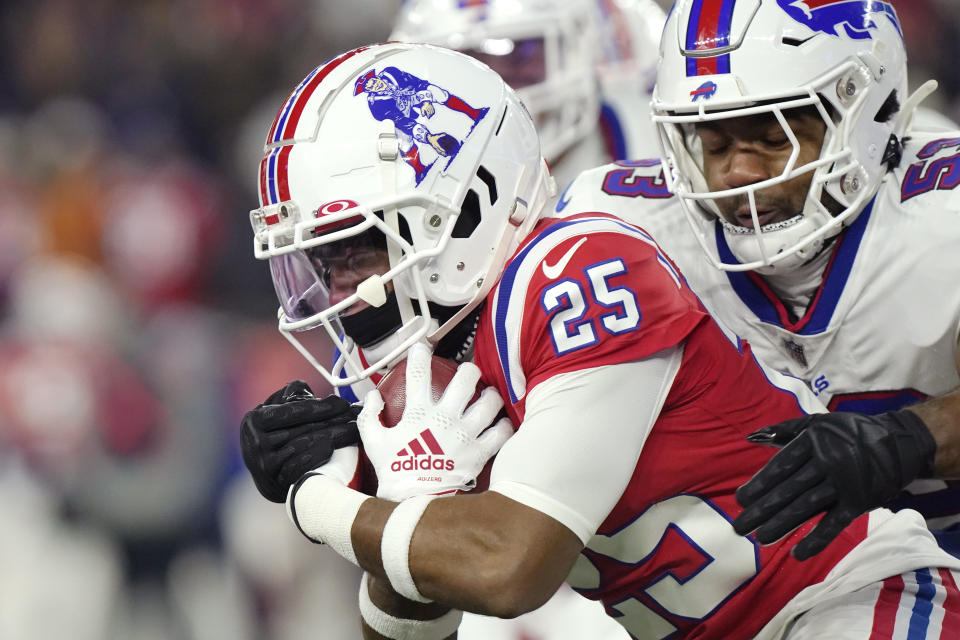 New England Patriots cornerback Marcus Jones (25) tries to break free from Buffalo Bills linebacker Tyrel Dodson (53) during the first half of an NFL football game, Thursday, Dec. 1, 2022, in Foxborough, Mass. (AP Photo/Steven Senne)