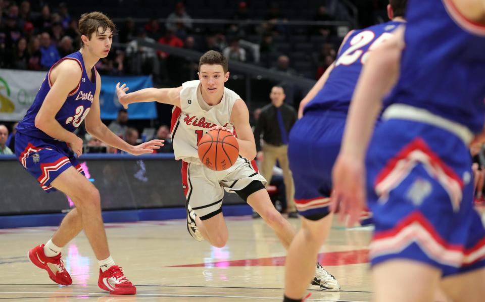 Hiland guard Sammy Detweiler, center, drives to the basket past Crestview forward Wren Sheets during the second half of a Division IV state semifinal basketball game at UD Arena, Friday, March 17, 2023, in Dayton, Ohio.