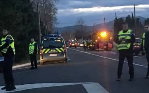 Police at the scene of the crash in local tv images A train and a school bus have collided near Perpignan in southern France, killing at least four people, - Credit: Telegraph