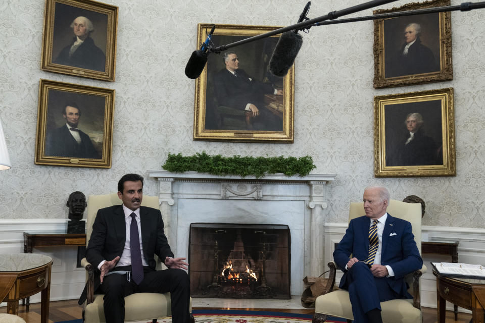 Qatar's Emir Sheikh Tamim bin Hamad Al Thani, left, speaks during a meeting with President Joe Biden in the Oval Office of the White House, Monday, Jan. 31, 2022, in Washington. (AP Photo/Alex Brandon)