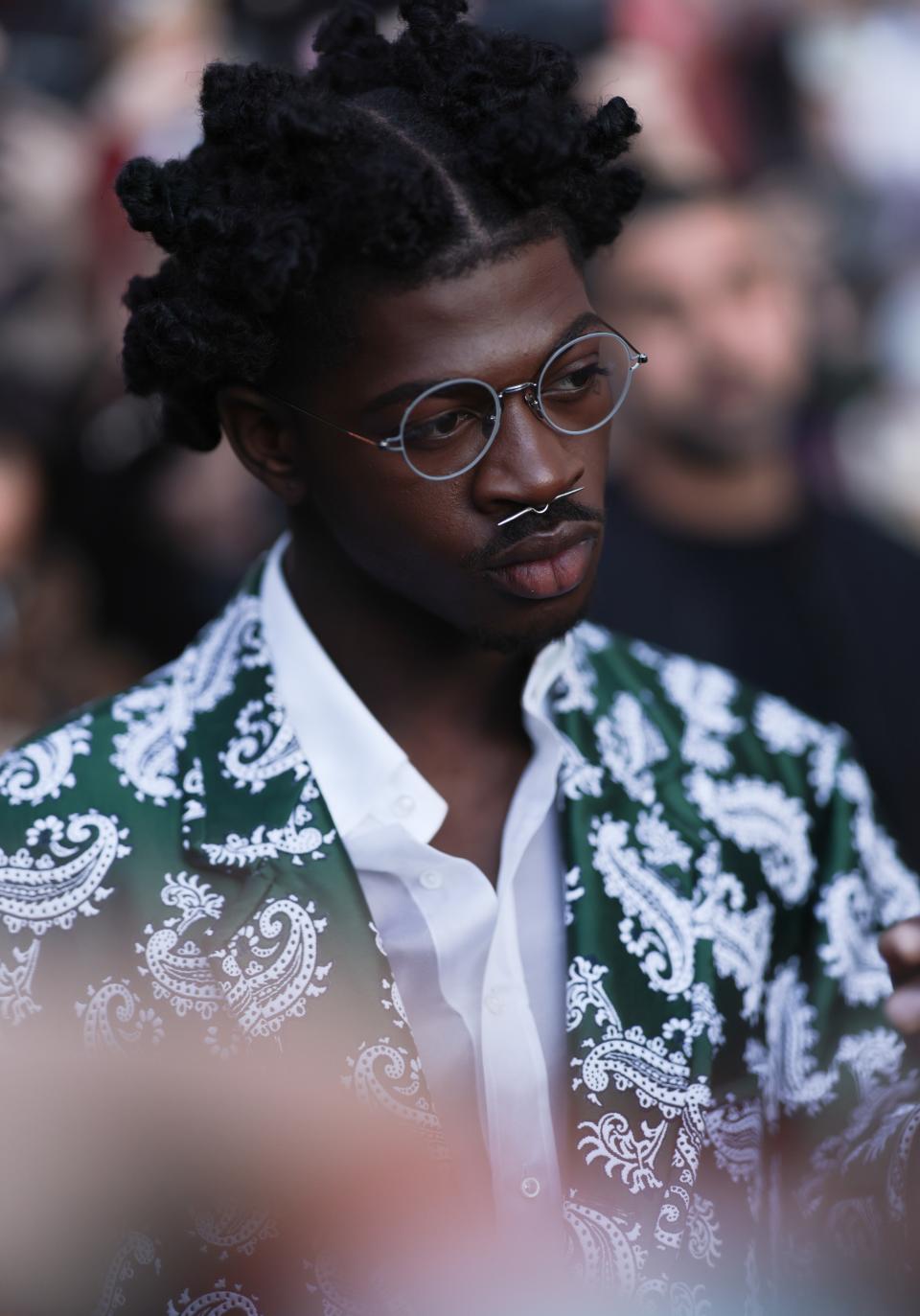 Lil Nas X wearing wire frame glasses. Photo by Jeremy Moeller/Getty Images.