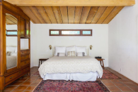 <p>The home has four large bedrooms, including this one with with tile floors. (Airbnb) </p>