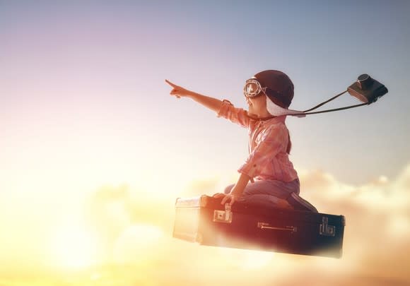 Child riding a rocket through the clouds.