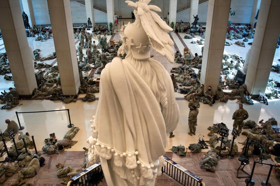 <p>Members of the National Guard rest in the Capitol Visitors Center on Capitol Hill in Washington, DC, January 13, 2021.</p>