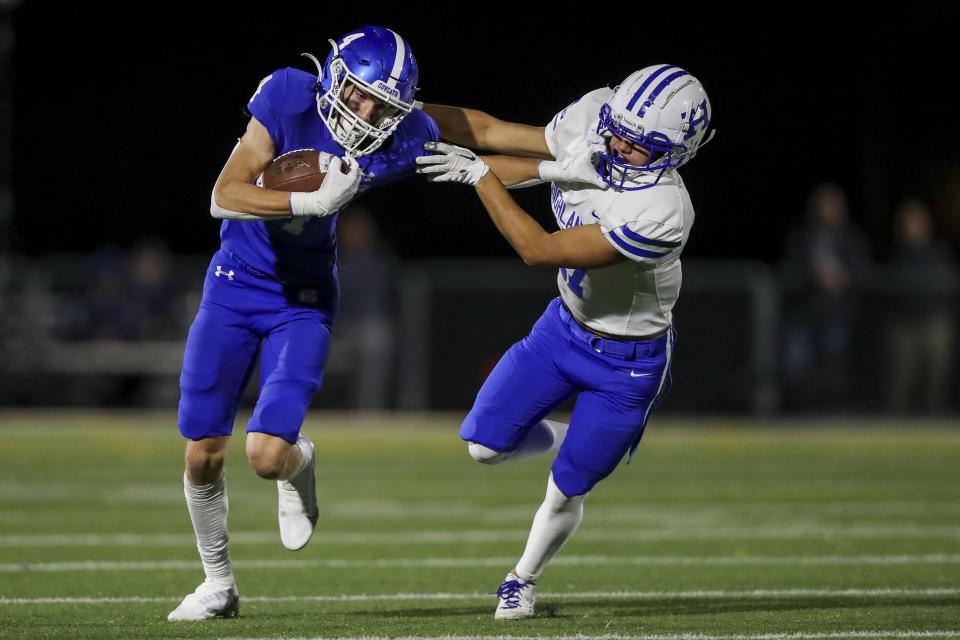 Covington Catholic wide receiver Oliver Link (4) runs with the ball against Highlands defensive back Brennan Kelsay (17) in the second half at Covington Catholic High School Oct. 14, 2022.