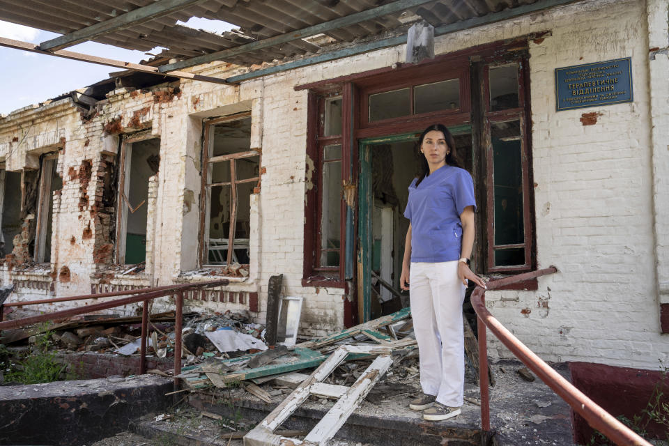 Dr. Ilona Butova stands in front of the therapy department which was destroyed after a Russia attack on the hospital in Zolochiv, Kharkiv region, Ukraine, Sunday, July 31, 2022. Ukraine's health care system already was struggling due to corruption, mismanagement and the COVID-19 pandemic. But the war with Russia has only made things worse, with facilities damaged or destroyed, medical staff relocating to safer places and many drugs unavailable or in short supply. (AP Photo/Evgeniy Maloletka)