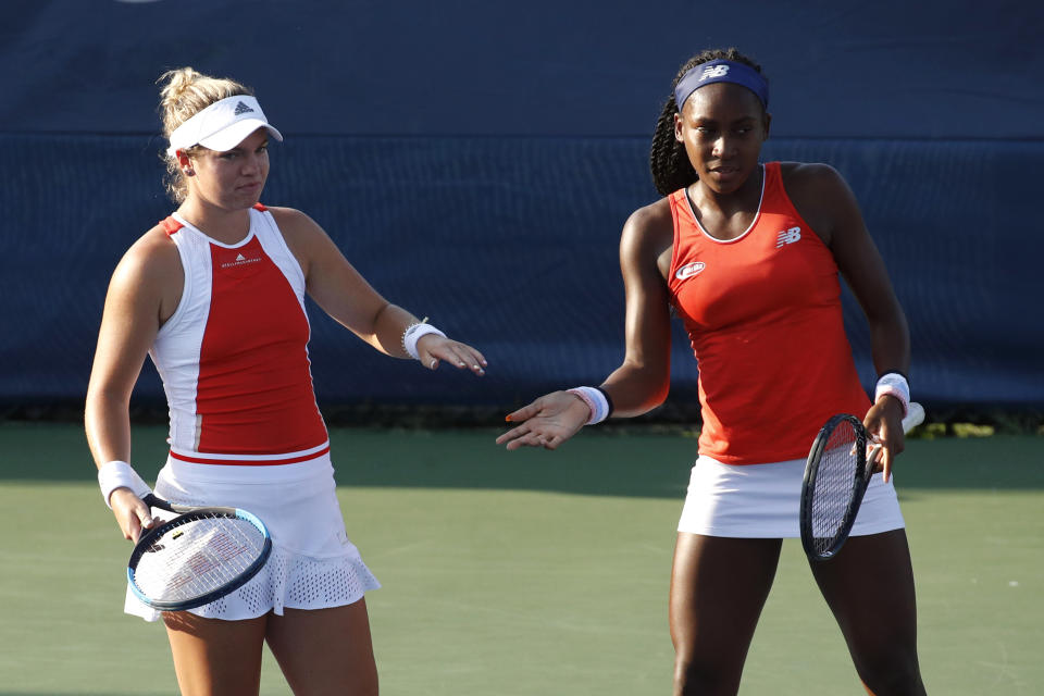 Caty McNally, left, slaps hands with Cori Gauff as they play the women's doubles final against Fanny Stollar, of Hungary, and Maria Sanchez at the Citi Open tennis tournament, Saturday, Aug. 3, 2019, in Washington. (AP Photo/Patrick Semansky)