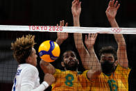 France's Barthelemy Chinenyeze, from left, Brazil's Wallace De Souza and Brazil's Lucas Saatkamp challenge for the ball during the men's volleyball preliminary round pool B match between Brazil and France at the 2020 Summer Olympics, Sunday, Aug. 1, 2021, in Tokyo, Japan. (AP Photo/Frank Augstein)