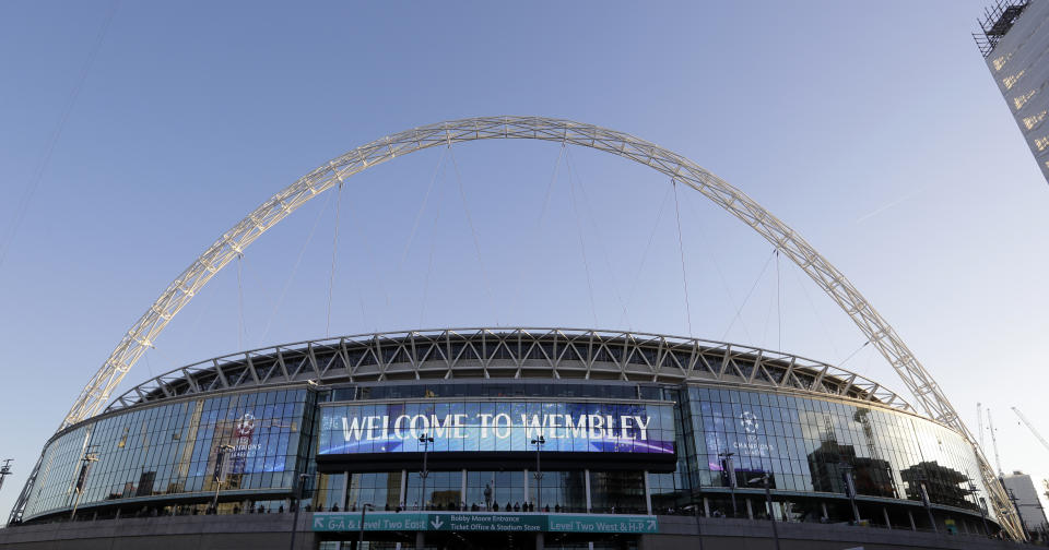 FILE - This Oct. 3, 2018 file photo shows a view of the exterior of Wembley Stadium in London. Supporters will attend soccer in Britain on Friday, July 31, 2020 for the first time since the country’s coronavirus lockdown four months ago. In a pilot event for the planned widespread return of supporters, 500 will be allowed into the Irish Cup final at 18,500-capacity Windsor Park. Northern Ireland is ahead of the rest of the U.K. Over in London on Saturday, England’s FA Cup final will be played without any spectators at Wembley. (AP Photo/Kirsty Wigglesworth, File)
