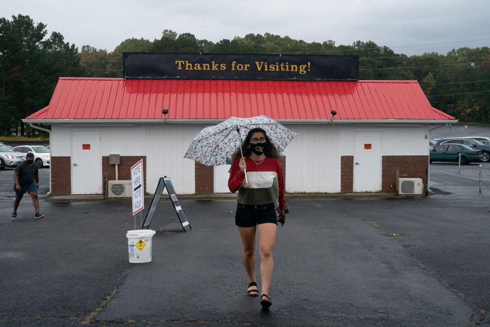 Georgia Tech student Claudia Gomez, 19, arrives at the Gwinnett County Fairgrounds to cast her first ballot on October 24, 2020, in Lawrenceville, Georgia. - Neighbors and volunteers are handing out water and snacks to the masked voters waiting patiently in line to cast their ballots on a hot October day in the Atlanta suburb of Smyrna. Americans go to the polls on November 3 but the enthusiastic early voting here has already given the morning an air of Election Day. Georgia has been a reliably Republican, conservative bastion and a Democrat has not won in the Peach State since Bill Clinton, a fellow Southerner, in 1992. But Democratic candidate Joe Biden, 77, and Republican incumbent Donald Trump, 74, are running neck-and-neck in the polls in Georgia. (Photo by Elijah Nouvelage / AFP) (Photo by ELIJAH NOUVELAGE/AFP via Getty Images)