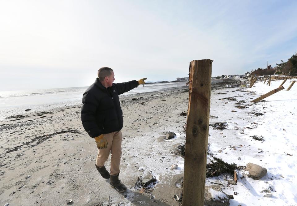 Ken Mason, the innkeeper of the Seaside Inn in Kennebunkport, shows how high the ocean water reached when it demolished the seawall and the dunes in front of his property.