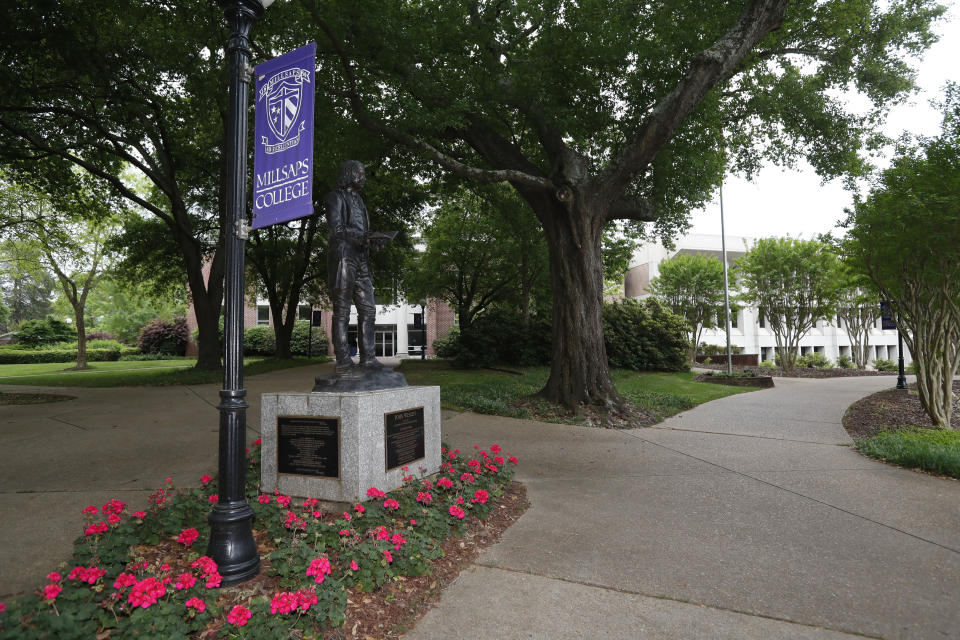 Students who usually flock past the statue of John Wesley, founder of the Methodist Church, while walking to class at Millsaps College in Jackson, Miss., are gone in face of the coronavirus Friday, April 3, 2020. The private liberal arts college, affiliated with the United Methodist Church, faces a different set of financial and enrollment challenges because of the virus. At present, the school has switched to on-line teaching. (AP Photo/Rogelio V. Solis)