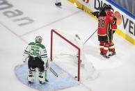 Calgary Flames' Elias Lindholm (28) and Mikael Backlund (11) celebrate a goal as Dallas Stars goalie Anton Khudobin (35) looks to the net during the second period in the first round NHL Stanley Cup playoff hockey series, Friday, Aug. 14, 2020, in Edmonton, Alberta. (Jason Franson/The Canadian Press via AP)