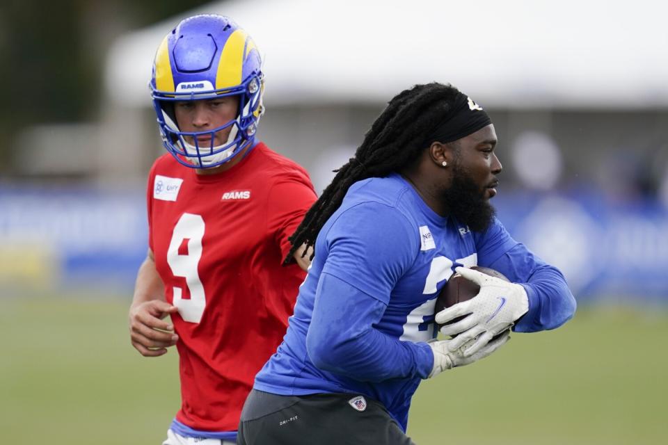 Rams quarterback Matthew Stafford (9) and running back Darrell Henderson Jr. (27) participate in drills.