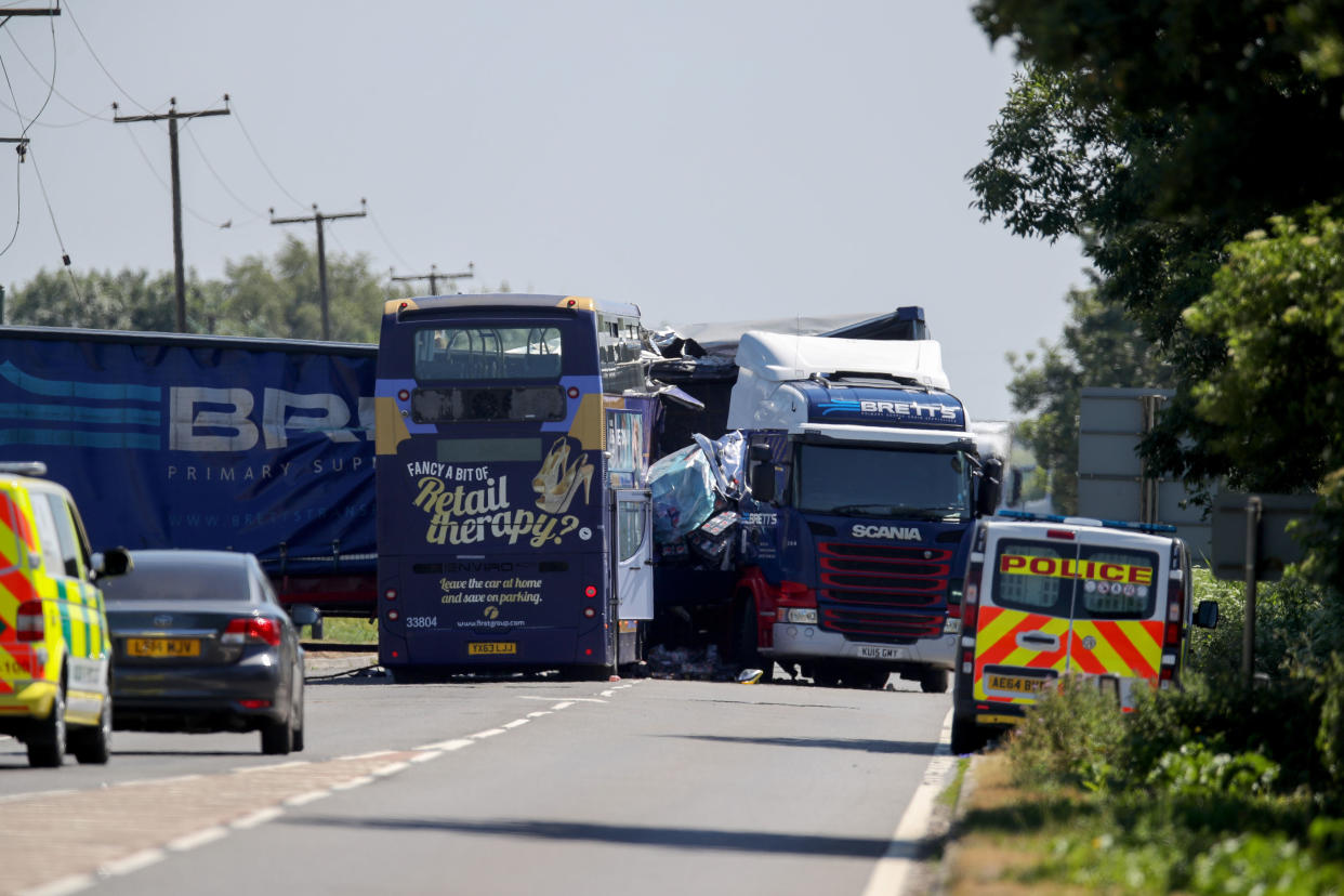 A bus and an articulated lorry on the A47 at Thorney Toll near Wisbech in Cambridgeshire following a collision earlier this morning (PA Images)