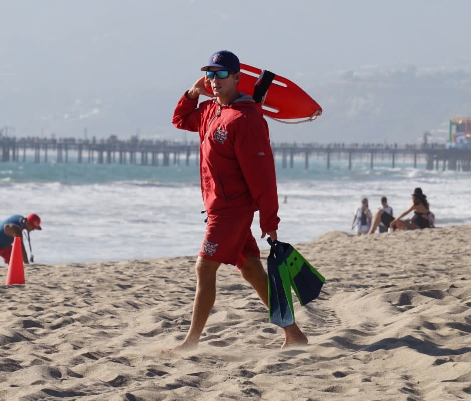 <p>Here’s one that’s particularly easy to pull off if you live in a warmer climate. It doesn’t get much simpler: Just wear a solid-color, neutral tank top over some tailored, above-the-knee swim trunks and a pair of <a href="https://www.mensjournal.com/style/best-mens-sandals-flip-flops-summer" rel="nofollow noopener" target="_blank" data-ylk="slk:flip-flops;elm:context_link;itc:0;sec:content-canvas" class="link ">flip-flops</a>. Accessorize with sunglasses, a bottle of sunscreen and—if you have one laying around—a whistle to keep the party under control. Just like that, you’re beach-ready. Or at least you’ll look the part as you stroll to the fridge for another Halloween party brew.</p>