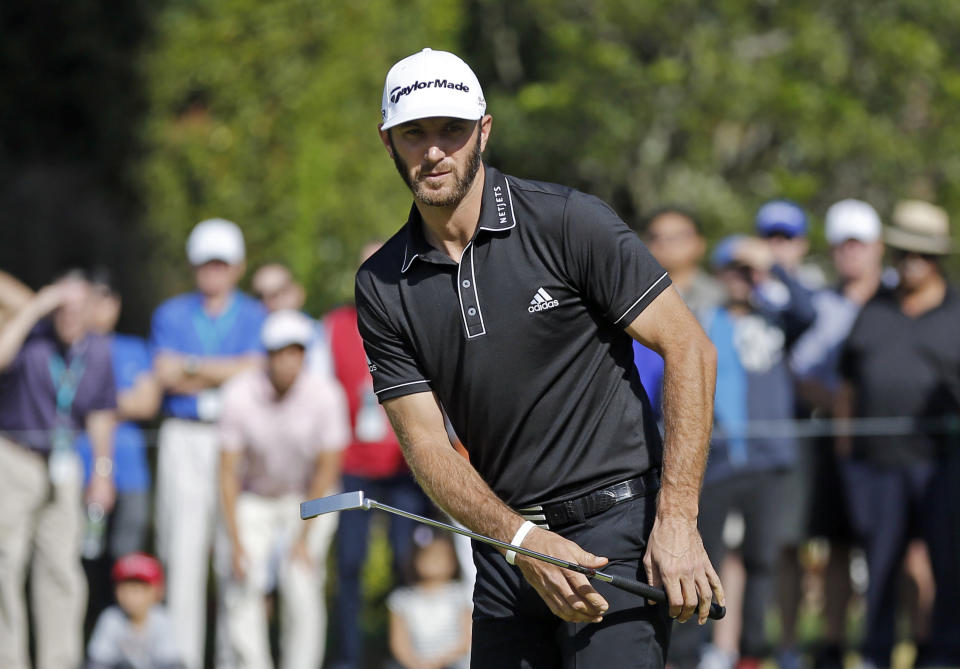 Dustin Johnson watches his birdie putt go into the hole on the first green in the final round of the Northern Trust Open golf tournament at Riviera Country Club in the Pacific Palisades area of Los Angeles, Sunday, Feb. 16, 2014. (AP Photo/Reed Saxon)