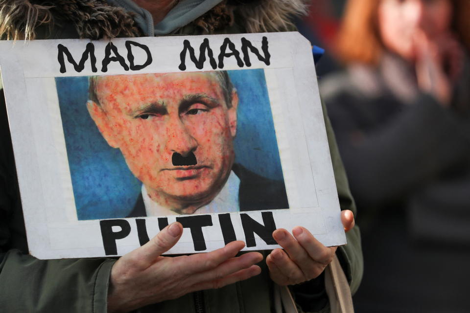 A person holds a placard depicting Russian President Vladimir Putin during a protest against Russia's invasion of Ukraine, in Edinburgh, Scotland, Britain, March 6, 2022. REUTERS/Russell Cheyne