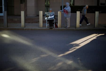 Demonstrators hold an "Interfaith Prayer Vigil for Immigrant Justice" outside the federal building, where ethnic Chinese Christians who fled Indonesia after wide scale rioting decades ago and overstayed their visas in the U.S. must check-in with ICE, in Manchester, New Hampshire, U.S., October 13, 2017. REUTERS/Brian Snyder