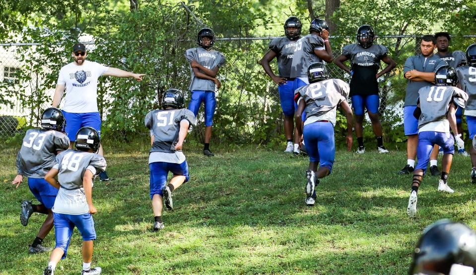 Randolph head coach Jonathan Marshall instructs his players through a conditioning drill during a football practice on Monday, August 29, 2022.