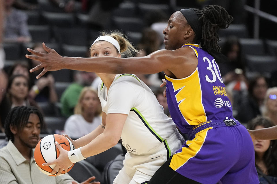 Minnesota Lynx guard Rachel Banham, left, tries to pass while under pressure from Los Angeles Sparks forward Nneka Ogwumike during the first half of a WNBA basketball game Tuesday, June 20, 2023, in Los Angeles. (AP Photo/Mark J. Terrill)