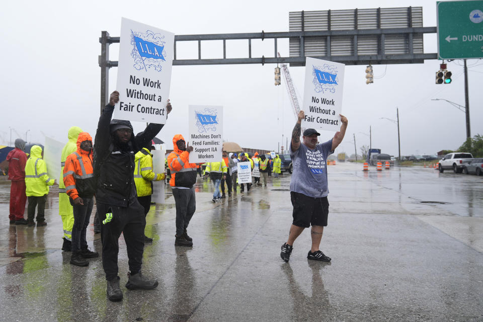 Dockworkers strike at the entrance to a container terminal at the Port of Baltimore, Tuesday, Oct. 1, 2024, in Baltimore. (AP Photo/Stephanie Scarbrough)