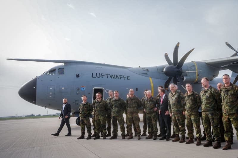 German Minister of Defense Boris Pistorius (C) bids farewell to the pre-commando of the Lithuanian brigade at the military section of Berlin-Brandenburg Airport. The army inspector will then fly to Lithuania with his soldiers in an Airbus A400M. Kay Nietfeld/dpa