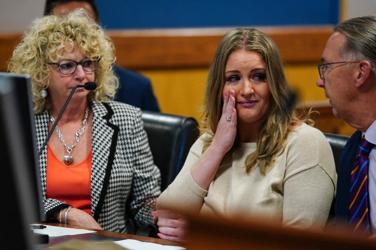Jenna Ellis reacts with her lawyers after reading a statement pleading guilty to a felony connected to Georgia election interference case on 24 October (POOL/AFP via Getty Images)