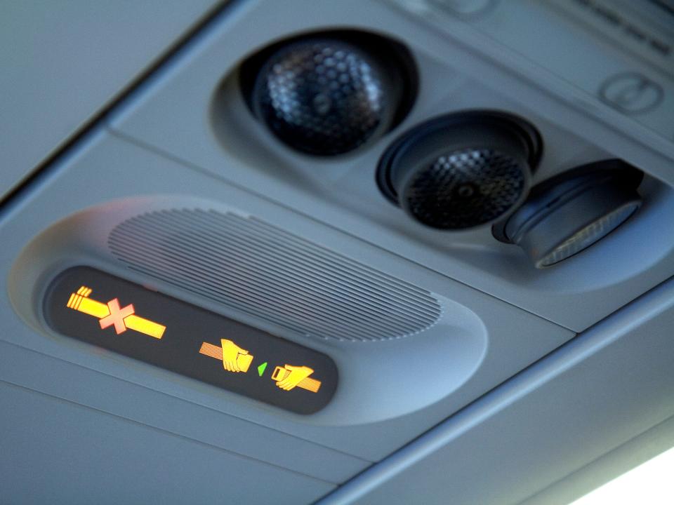 A "no smoking" and "fasten seatbelt" sign on a commercial aircraft.