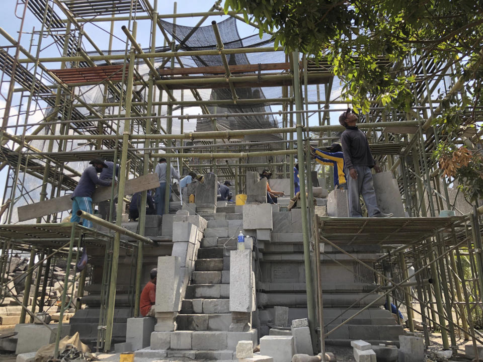 In this July 29, 2019, photo, workers renovate a temple at Prambanan Temple Complex in Yogyakarta, Indonesia. The Indonesian city of Yogyakarta and its hinterland are packed with tourist attractions, including Buddhist and Hindu temples of World Heritage. Yet many tourists still bypass the congested city and head to the relaxing beaches of Bali. Recently re-elected President Joko Widodo wants to change this dynamic by pushing ahead with creating "10 new Balis," an ambitious plan to boost tourism and diversify South Asia's largest economy. (AP Photo/Karin Laub)