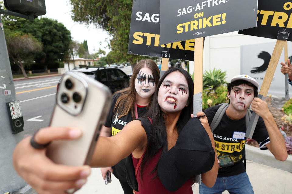 SAG-AFTRA members pose for a picture as they walk the picket line during their ongoing strike outside Sony Studios in Culver City, California, U.S. September 29, 2023. REUTERS/Mario Anzuoni