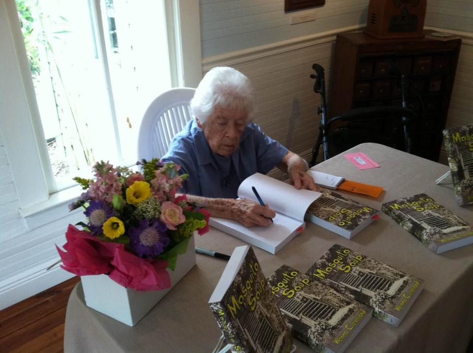 Weona Cleveland signs copies of her 2013 book "Mosquito Soup" during an event at the Rossetter House Museum in Eau Gallie.