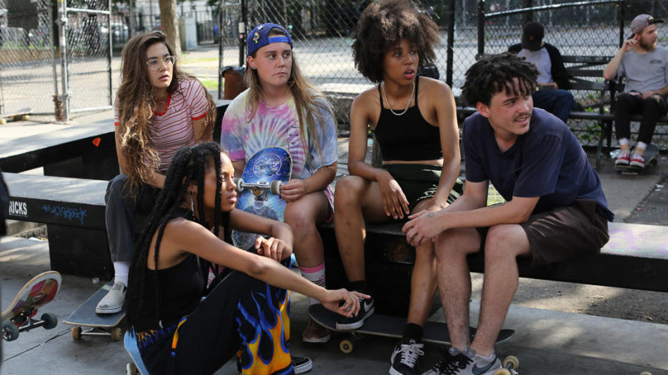 The girls in "Skate Kitchen" glide through the New York streets, skateboards propelling their adolescent odyssey. This motley clique -- made up of different races, sexualities, temperaments, insecurities --&nbsp;have a preternatural connection, catching one another when they fall and absorbing each other's lives the way only teenagers can.&nbsp;<br /><br />Director Crystal Moselle, who made the 2015 documentary "The Wolfpack," said she met the&nbsp;group on the subway. Incorporating&nbsp;their real personas, she scripted a gauzy narrative about a shy newcomer (Rachelle Vinberg) who finds refuge with this very different sort of wolf pack. Invoking shades of "Kids" and "American Honey," "Skate Kitchen" is&nbsp;a v&eacute;rit&eacute; ollie full of life at its most bittersweet and its most vivacious. The plot is loose in the best sense, and the results make for a serene jaunt through the fleeting, beautiful&nbsp;days that will&nbsp;soon make these girls -- and the boys who surround them, including one played by Jaden Smith -- nostalgic for their youth. -- <i>MJ</i>