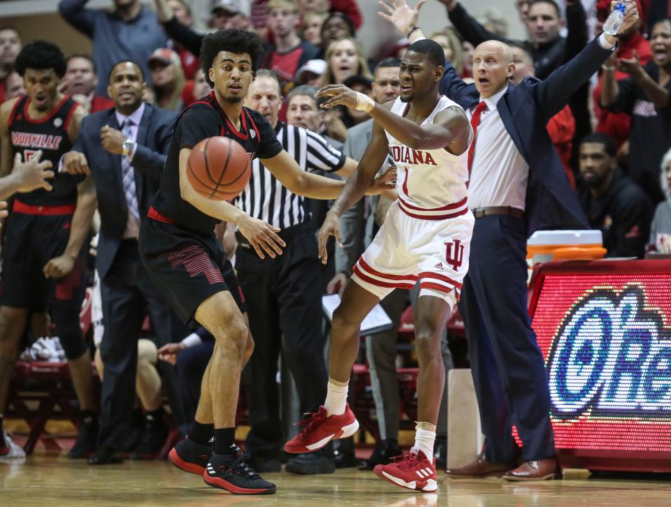Louisville's Jordan Nwora pressures Indiana's Aljami Durham Saturday, Dec. 8, 2018. Cardinal coach Chris Mack, seen from the sideline, said afterwards: "As I told our guys, you're going to have times where even the best teams on offense don't score four or five possessions in a row, and we've got to be able to keep the other team from scoring. We didn't do that." 