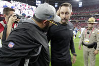 Detroit Lions head coach Matt Patricia, left, greets Arizona Cardinals head coach Kliff Kingsbury after an NFL football game, Sunday, Sept. 8, 2019, in Glendale, Ariz. The Lions and Cardinals played to a 27-27 tie on overtime. (AP Photo/Darryl Webb)