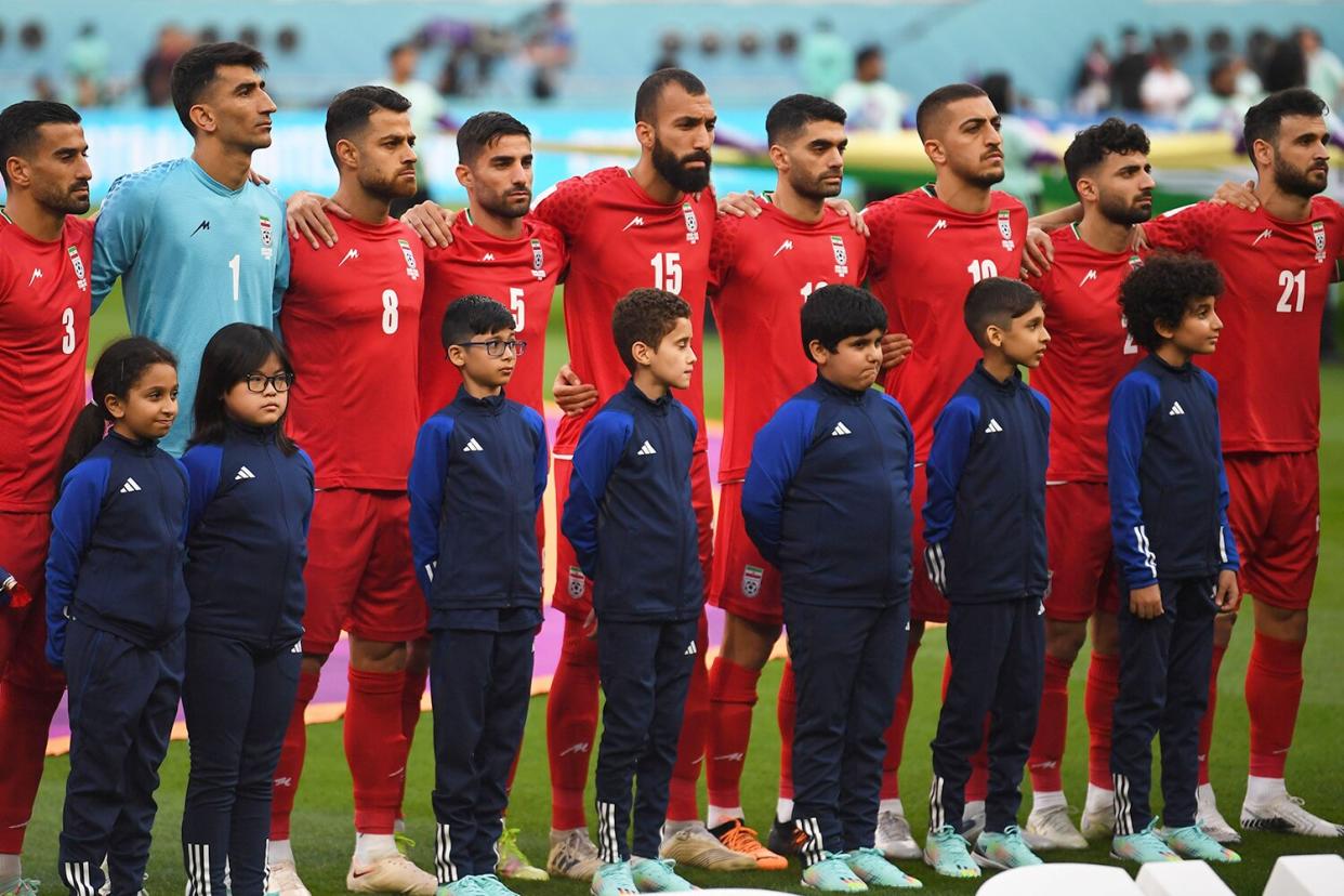 Players of Iran stand during their national anthem prior to the FIFA World Cup 2022 group B soccer match between England and Iran at Khalifa International Stadium in Doha, Qatar, 21 November 2022.