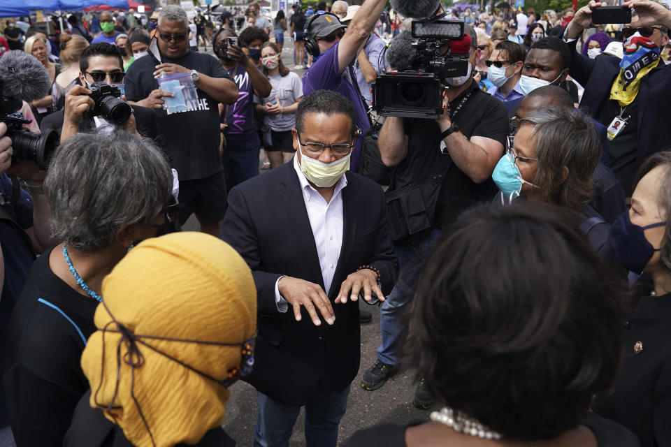 FILE - In this June 4, 2020 file photo, Minnesota Attorney General Keith Ellison, center, speaks with Rep. Ilhan Omar, D-Minn., and members of the Congressional Black Caucus as they visited the site of George Floyd's death in south Minneapolis. Taking over as lead prosecutor in George Floyd's death, is giving Ellison a national platform to talk about race in America. And while Ellison is careful not to talk about details of the criminal cases against four Minneapolis police officers, he's grabbing the opportunity to raise issues about police reform that he's worked on in the past. (Anthony Souffle/Star Tribune via AP, File)