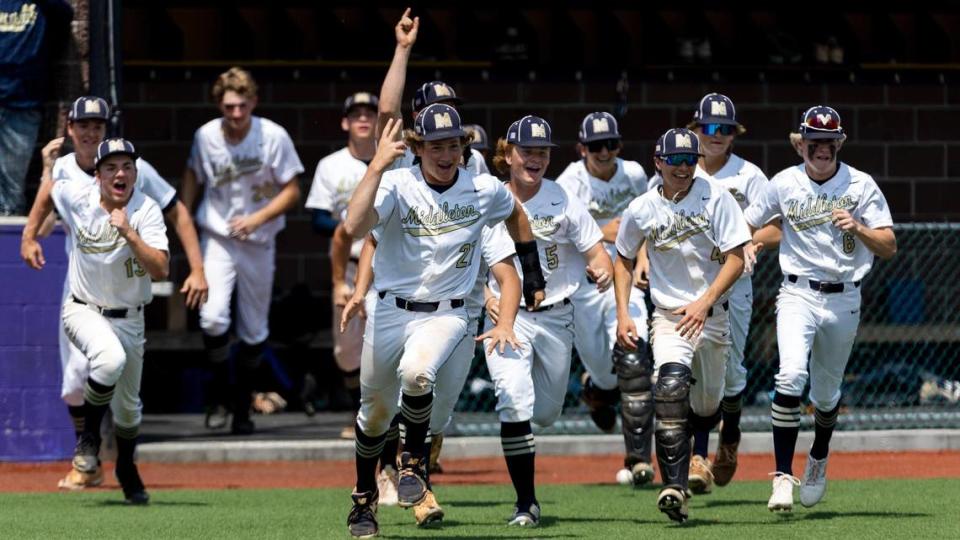 Middleton’s bench rushes onto the field after teammate Isaiah Anzaldua’s walk-off single lifted the Vikings to a 2-1 win over Timberline in the first round of the 5A baseball state tournament.