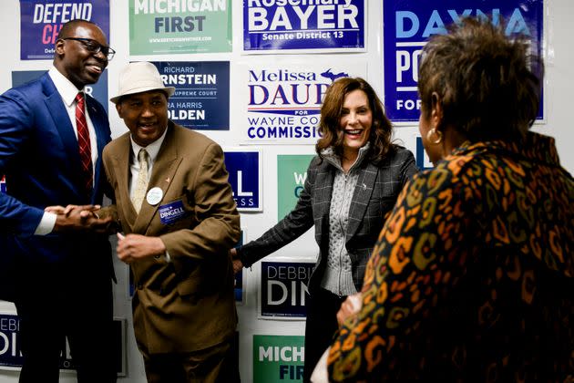 Whitmer greets Rodrick Casey, left, and Pecola Lewis, right, both of Ypsilanti Township, for a photo opportunity following a campaign event at a local campaign office in Canton on Oct. 26. (Photo: (Brittany Greeson for HuffPost))