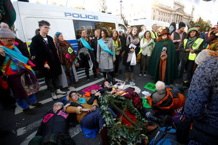 Protesters sit in the road outside the Houses of Parliament during a demonstration against fracking, in London, Britain, October 31, 2018. REUTERS/Henry Nicholls