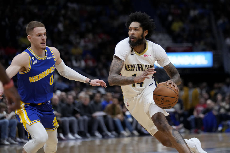 New Orleans Pelicans forward Brandon Ingram (14) drives the lane past Golden State Warriors guard Donte DiVincenzo (0) in the first half of an NBA basketball game in New Orleans, Monday, Nov. 21, 2022. (AP Photo/Gerald Herbert)