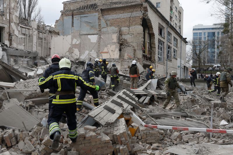 Rescuers work at the site of a building damaged by a Russian missile strike, in Kyiv