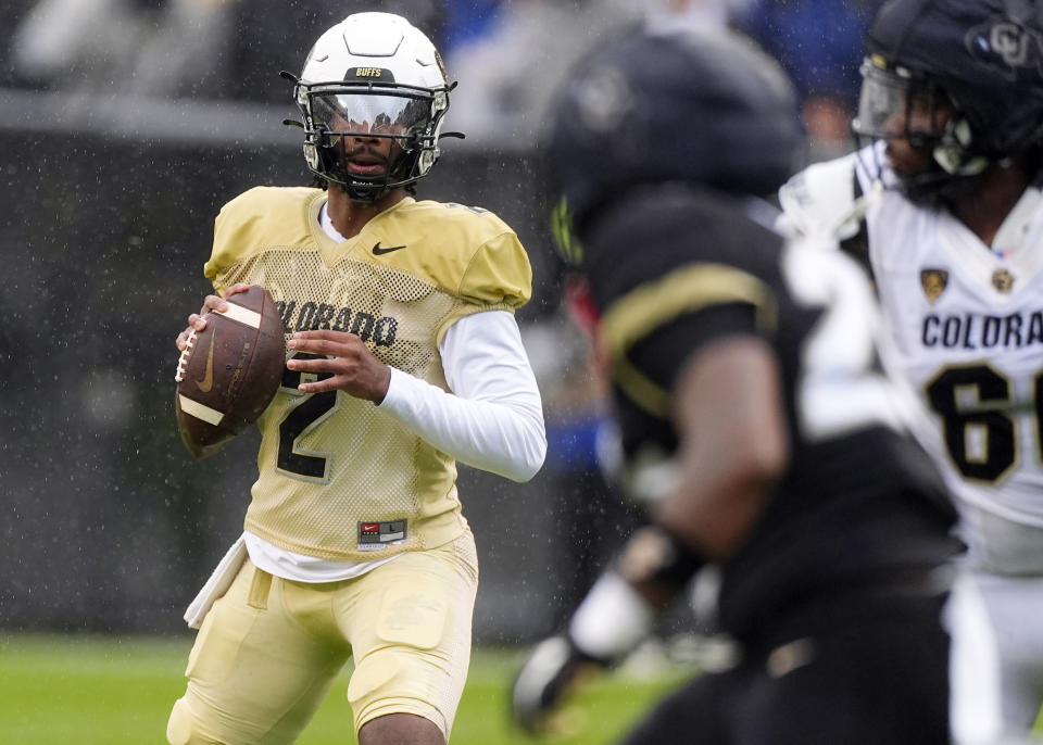 Colorado quarterback Shedeur Sanders drops back to pass during the first half of the team's spring NCAA college football game Saturday, April 27, 2024, in Boulder, Colo. (AP Photo/David Zalubowski)