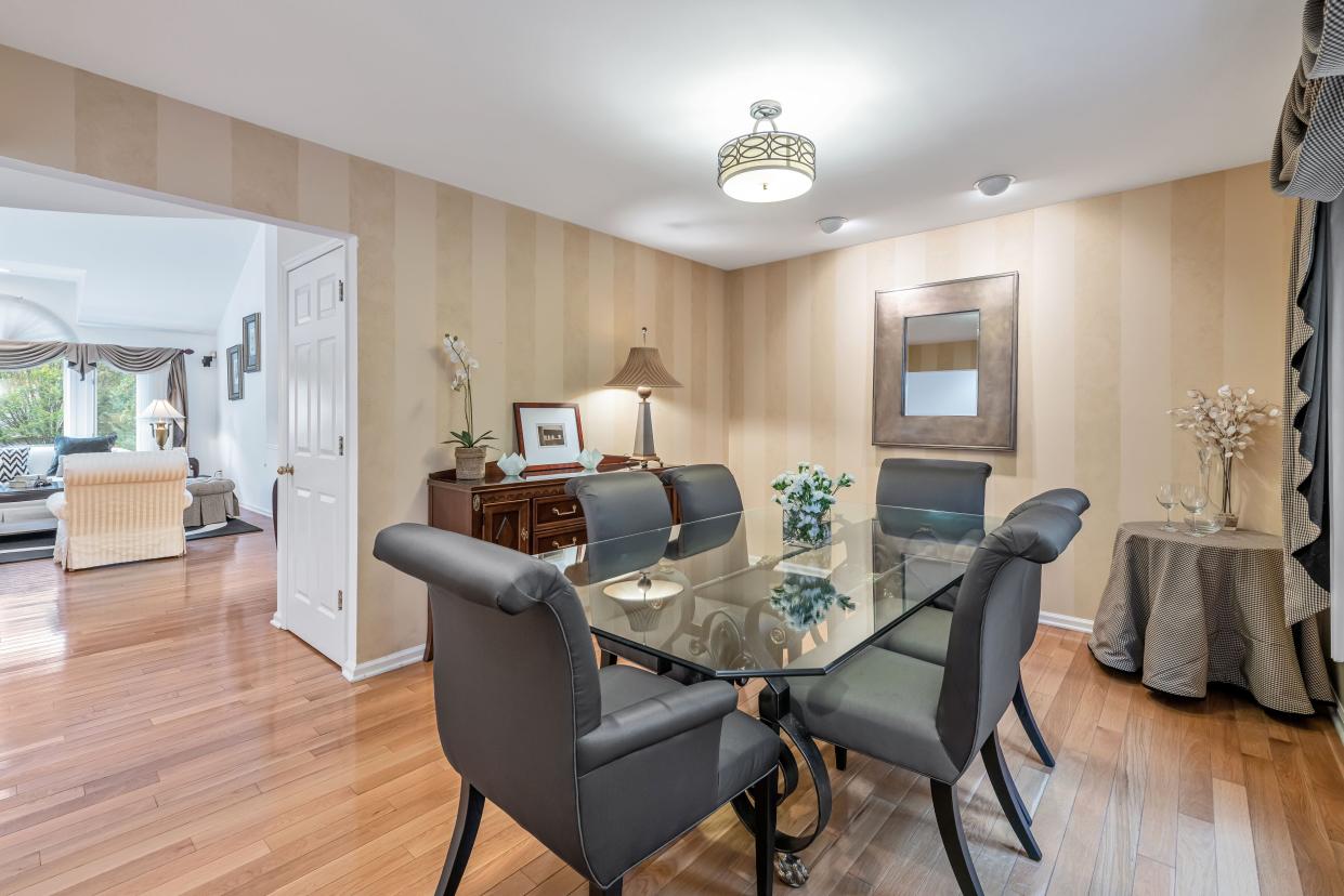 The dining room of a townhouse in Old Tappan, which is separated from the home's living room.