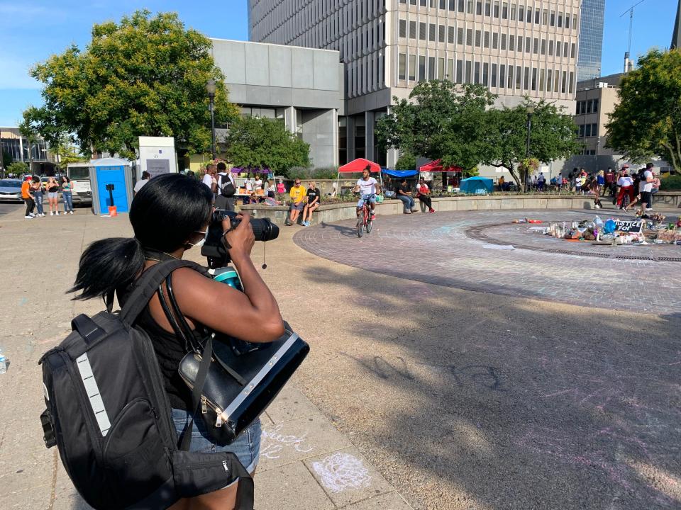 Selina Marlow, a 33-year-old Black woman, took a photograph on Tuesday at Jefferson Square Park. “I have a 2-year-old. This is her future," she said.
