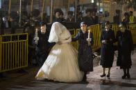 <div class="caption-credit">Photo by: Getty Images</div>The 19-year-old bride, Hannah Batya Penet, wore a traditional white wedding dress made of lace and encrusted with pearls and crystals. Female relatives led her into the ceremony. Though the bride was surrounded by thousands of well-wishers, she wore a heavy veil throughout the ceremony, keeping her face hidden from her guests.